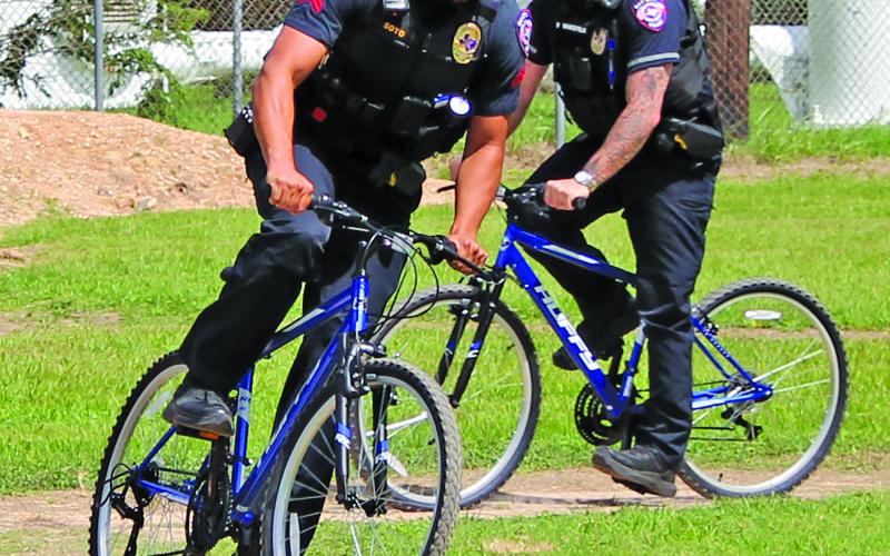 Sentinel Photo/Jessica Shepard Two Bay City Police officers were among several bicycle riders at the grand opening of Bay City's new "BMX Bike Park" Saturday, June 29. The BMX Bike Park is at 3212 Ave. E by the water tower
