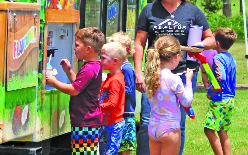 Sentinel Photo/Jessica Shepard Free snow cones were just a part of the summertime fun at El Maton National Hall last week. The Wednesday, July 31, event featured water slides, a water-filled volleyball court, bubble machine, snacks, water balloons, and a train ride for kids of all ages. Attendees also registered for a chance to win several door prizes including gift buckets and various inflatable toys.
