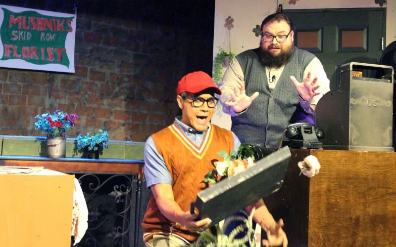 Sentinel Photo/Jessica Shepard Seymour Krellborn (Ray Garcia), left, makes a comedic entrance when bringing Mr. Mushnik (Matthew Boren), right, a tray of plants to show off his work progress as part of the Community Actors of South Texas (CAST) press night preview of "Little Shop of Horrors" Aug. 1. Tickets for the production are limited and selling out fast online.