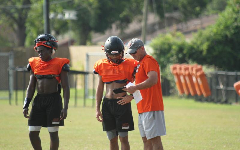 Anna Hernandez photo Van Vleck Head Coach Shannon Perneter goes over plays with a player.