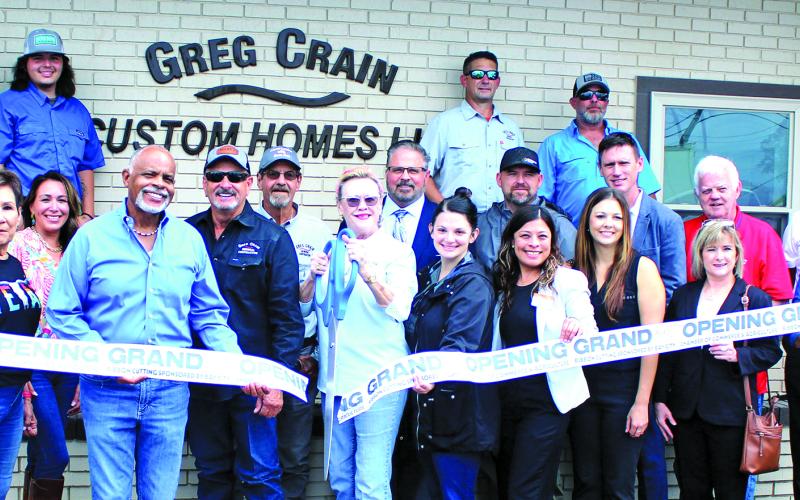 Greg Crain Custom Homes partnered with the Bay City Chamber of Commerce &amp; Agriculture for an open house ribbon-cutting ceremony on July 24. Crain, center, is joined by Richie and Nancy Mayhew and several employees at the event. The business is located at 520 Ave. F in Bay City. Sentinel Photo/ Jesssica Shepard
