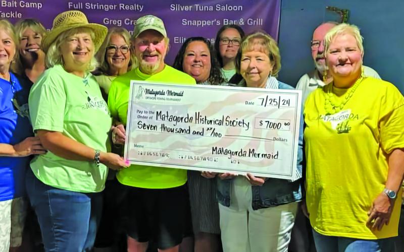 Courtesy photo Matagorda Historical Society (MHS) members thanks the Matagorda Mermaid Tournament for their continued support of their organization. The donation enabled MHS to repair and restore much of Matagorda Heritage Park and the historic buildings on the park property.