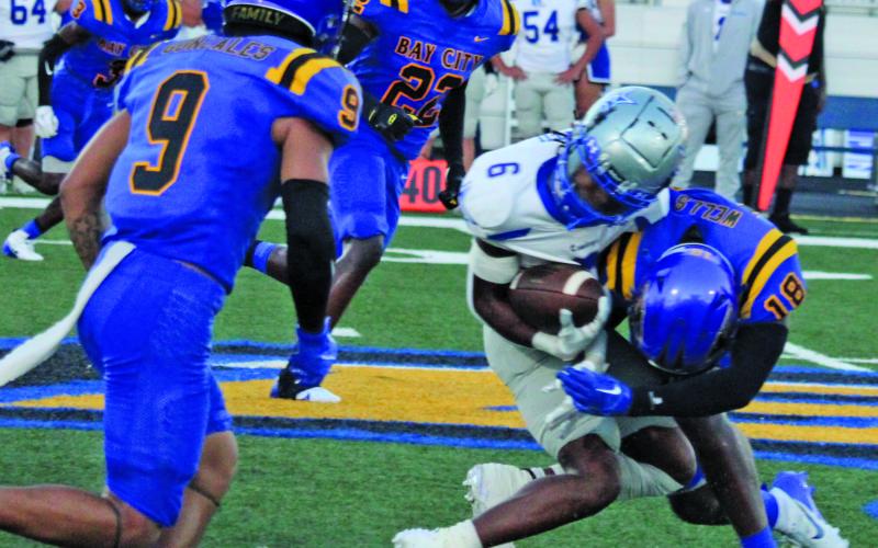 Sentinel Photos/Mike Reddell Bay City junior safety Trevell Wells (18) makes a crushing stop on an Edna running back, as Blackcat defenders Isiah Gonzales (9) and James Copland (22) close in.