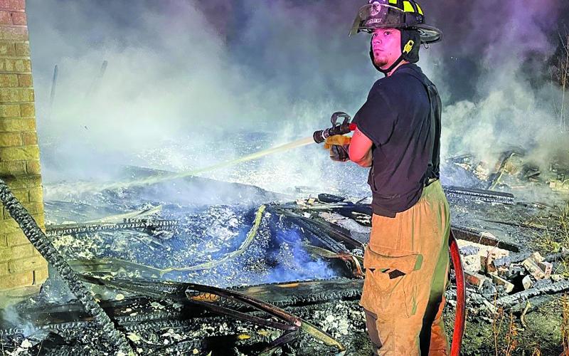 Contributed photo Firefighter battles the hot spots at a Van Vleck vacant house.