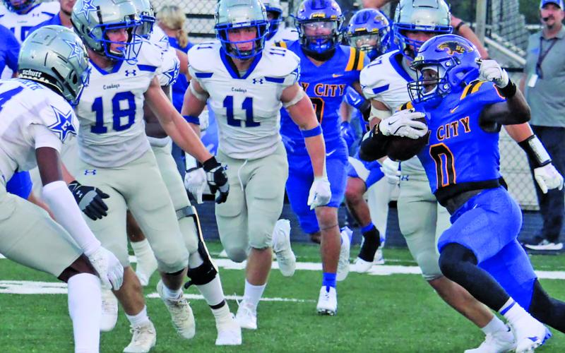 Sentinel Photos/Mike Reddell Bay City senior running back Jada Andrews (0) confronts a crowd of Edna defenders here Friday night.