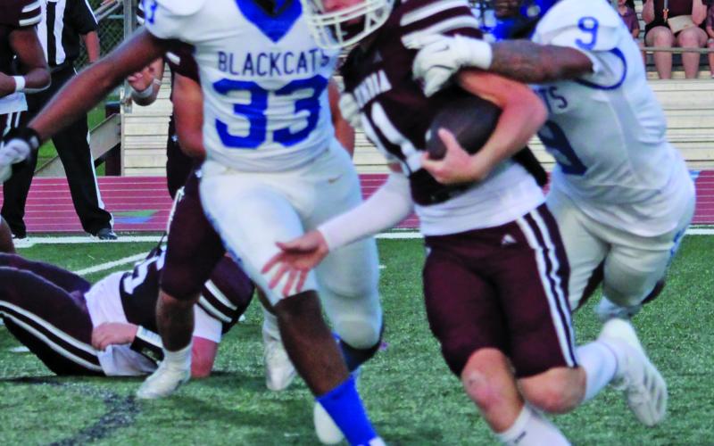 Sentinel Photo/Mike Reddell Bay City junior defensive end Jordan O’neal (33) and senior linebacker Isaiah Gonzalez (9) combine to bring down a Roughneck running back.