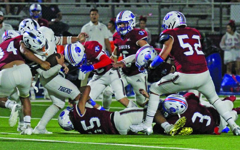 Photo by Anna Hernandez Tidehaven tacklers converge on a Goliad running back in the Tigers matchup against Goliad last week.