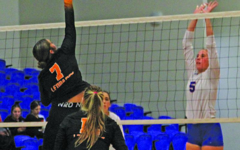 Photo by Anna Hernandez Above right, Van Vleck’s Lakyn Matchett (7) tips the ball over the net with Tidehaven’s  Raylea Kelley (5) defending during the game between the two Matagorda County teams Aug. 27. Tidehaven won 3-0.