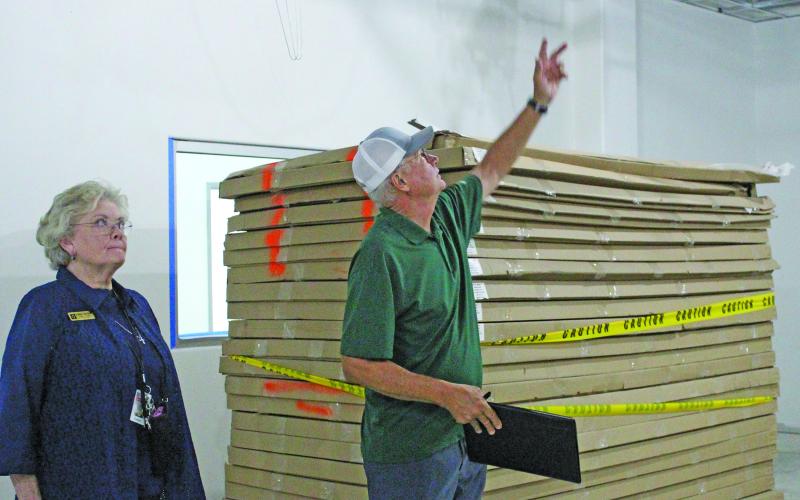 Sentinel Photo/Jessica Shepard Wharton County Junior College WCJC Facilities Management Advisor Mike Feyen, right, points out where carpentry workstations will be located during a recent walk-through tour of the college's new trades and carpentry expansion.