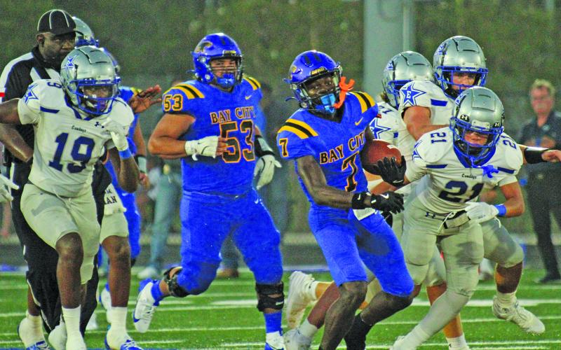 Photo by Anna Hernandez Bay City senior wide receiver Xylan Williams (7) sheds Edna defenders and takes off for a  76-yard touchdown catch in the second quarter last Friday, Sept.  6. Blackcat lineman Jakob Pesina (53) joins the blockers.