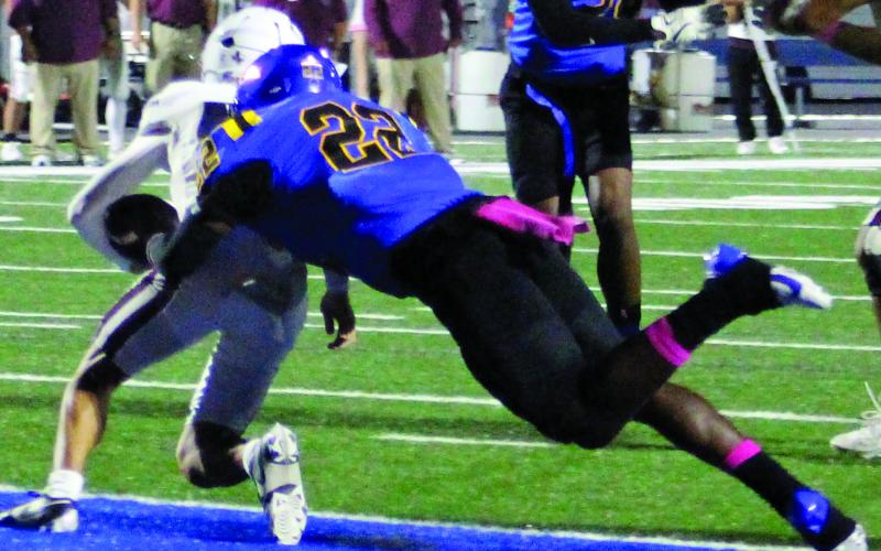 Sentinel Photo/Jessica Shepard Bay City linebacker James Copeland (22) makes a flying tackle on the Floresville quarterback for a safety.