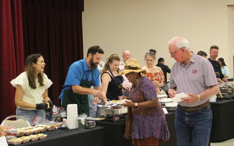 Sentinel photo/Jessica Shepard Donnye Stone, center with hat, shares the good-natured banter with one of the cooking teams at the Gourmet Guys fundraiser for the Matagorda County  Museum Saturday, Sept. 28.