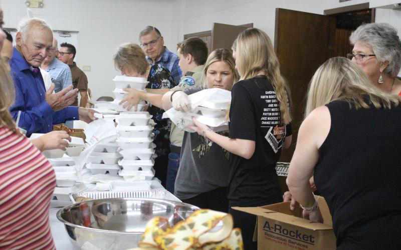 Sentinel Photo/Jessica Shepard Boxed lunches are prepared at the Holy Cross Catholic Church’s annual “Fall Festival and Turkey Dinner” Sunday, Sept. 29, at the Knights of Columbus Hall. In addition to the meals, the church’s event featured a live auction, raffle, country store, and children’s activities.