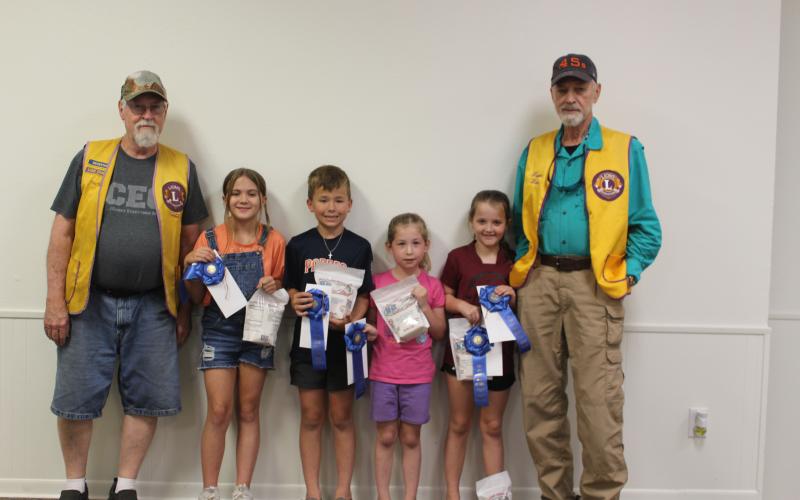 Sentinel Photo/Jessica Shepard Lion Tim Hall with "Rice Dish Roundup" winners from grades 1-5 are Grayson Reed, Carter Busby, Kendall Page, and Riley Lucas, with Lion Wayne Witte.