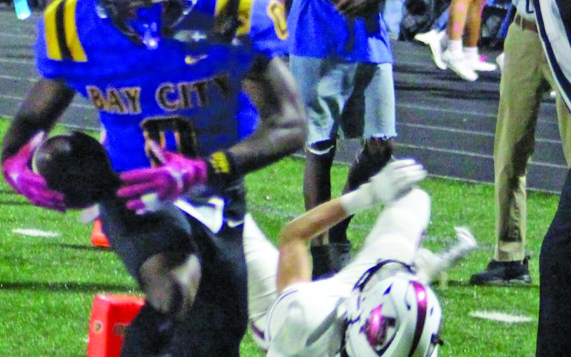 Sentinel Photo/Jessica Shepard Bay City’s Jada Andrews (0) sheds a Floresville tackler en route to the first of his three touchdowns on the night.