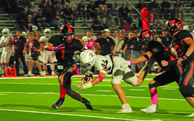 Photo by Anna Hernandez Leps Logan Carter (1) and Steve Moore (22) and another defender take down the Industrial ball carrier.