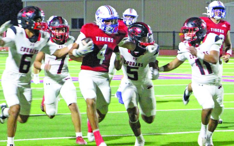 Sentinel Photo/Jessica Shepard Tiger running back Boogie Galvan (4) tries to shake several Brazos defenders.