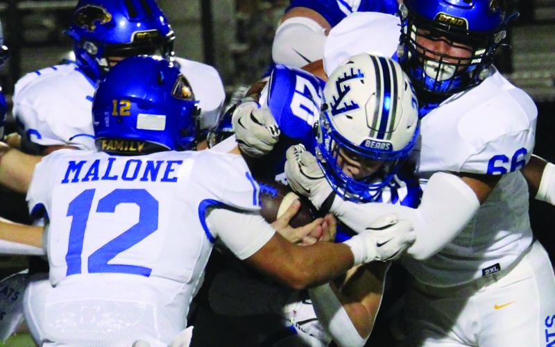 Sentinel Photo/Mike Reddell Bay City linebacker Jaden Malone  (12) and defensive lineman Camron Willis (66) join other Blackcats to make a stop on a La Vernia running back.