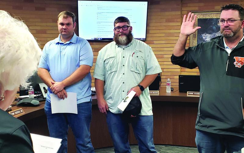 Sentinel Photo/Jessica Shepard Van Vleck ISD Superintendent Secretary Pat Hackworth, left, swore in three board members during the district's monthly trustee meeting Dec. 18. From left is Position  7 Dane Evans, Position 6 Charlie Hill, and Position 5 Casey Kile - all trustees were unopposed in the Nov. 5 election.