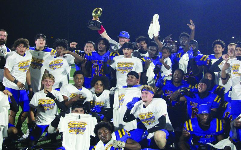 Sentinel Photo/Mike Reddell Blackcats celebrate winning the district championship trophy Friday night.