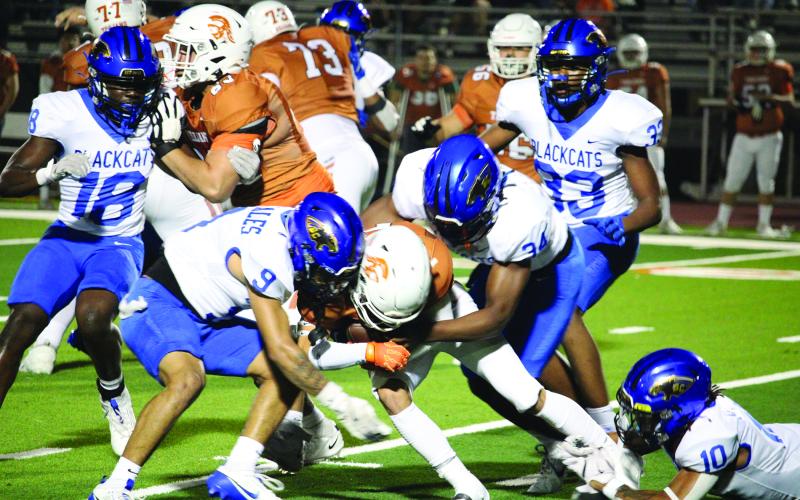 Sentinel Photo/Mike Reddell Senior linebacker Isaiah Gonzales (9) and defensive end Cameron Spencer (34) lead the group effort to stop a Beeville running back. They were joined by juniors Trevell Wells (18), Jordon O’Neal (33) and Davont’A Harris (10).