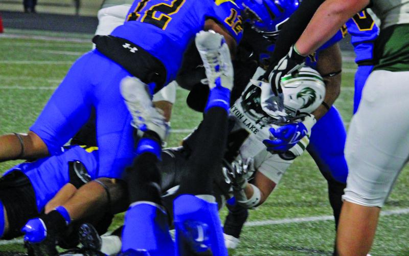Sentinel Photo/Mike Reddell Senior Blackcat linebacker Jaden Malone (12) is joined by other Bay City defenders in bringing down a Hawk running back.
