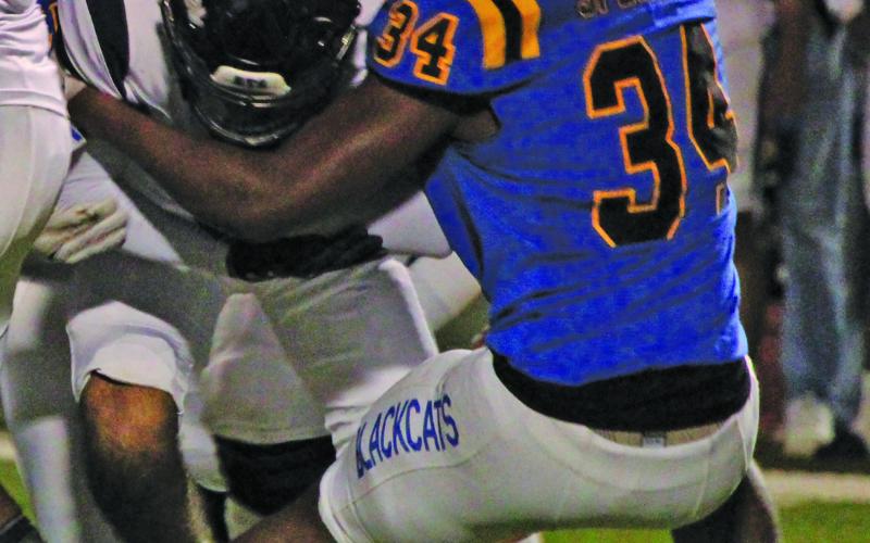 Sentinel Photo/Mike Reddell Blackcat senior defensive end Cameron Spencer (34) has a good grab on a Hidalgo running back.