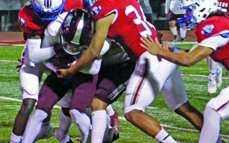 Sentinel Photo/Jessica Shepard Tidehaven defenders swarm over a Dilley running back at the area round of playoffs last week.
