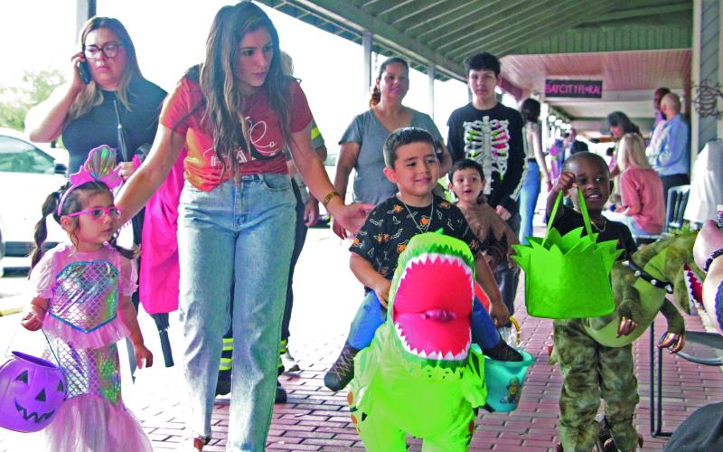 Sentinel Photo/Mike Reddell Halloween brought scores of trick-or-treaters to downtown last Thursday. Above, a few of the youngsters’ costumes on display.