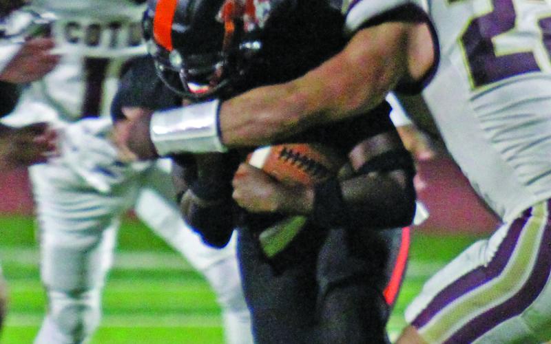 Photo by Anna Hernandez Leopard back Daniel Williams uses all his strength to move the ball down field while the Cotulla defense tries to bring him down.