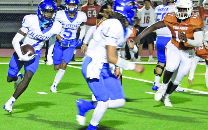Sentinel Photo/Mike Reddell Blackcat senior wide receiver Xylan Williams (7) looks for blocking as senior quarterback Alex Estrada (1) leads the way against Beeville Friday night.