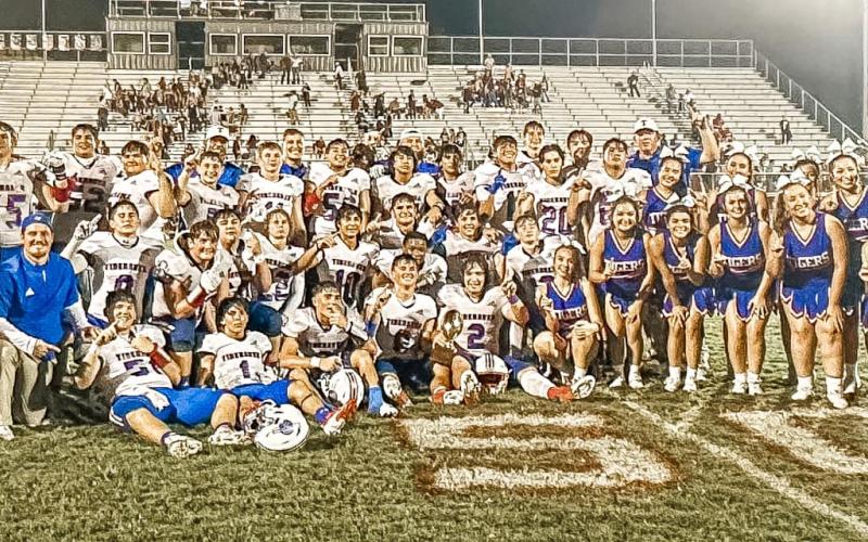 Photo/Lauren Russell Tidehaven players, cheerleaders, mascot and coaching staff celebrate the Tigers 3rd straight district championhip after defeating East Bernard Friday night.