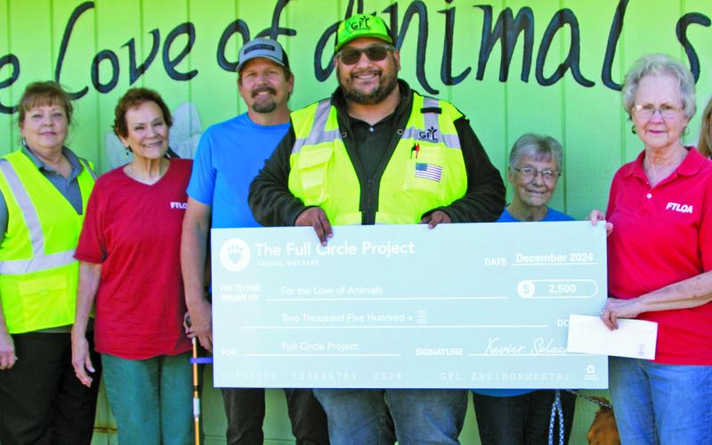 Sentinel photo by Jessica Shepard GFL Environmental personnel presented For the Love of Animals volunteers with a $2,500 check on Friday, Dec. 20. The check comes from "The Full Circle Project" - GFL's community charity program.