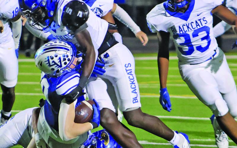 LeDarion Stone/Live in the Moment Photography Linebacker Jaden Malone and Aiden Williams tackle a La Vernia runner for a loss