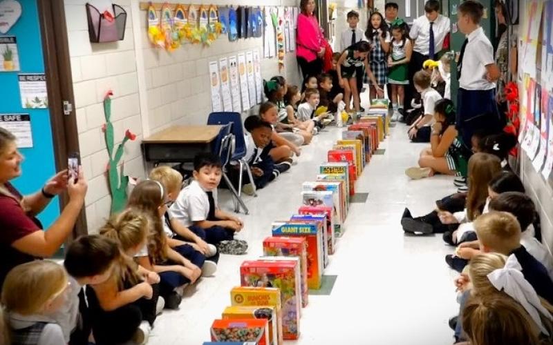 Holy Cross photo The 2024 Cereal Box Domino Run STEM project that Holy Cross Catholic School's 5th graders completed was a huge success. Now the boxes of cereal will be donated to the Harvest House Food Pantry  in Bay City.