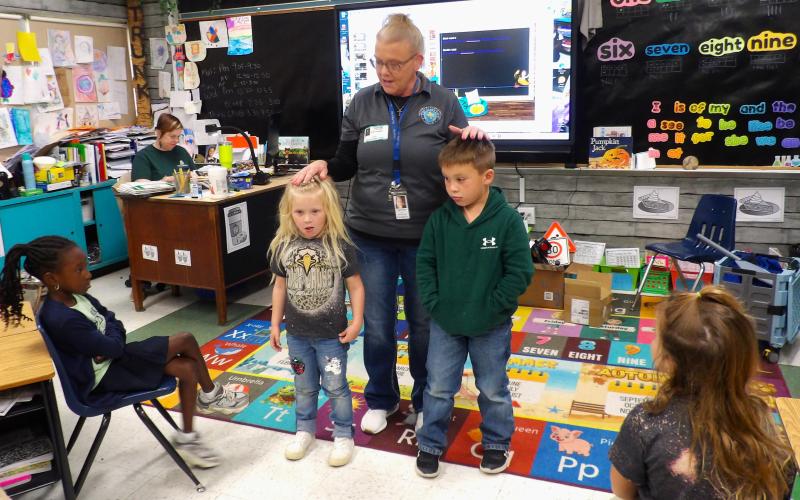Sentinel Photo/Mike Reddell Juvenile Case Manager Ginger Iovanna and Court Clerk Lillie Norris from Bay City Municipal Court recently visited Holy Cross students. They shared important traffic safety information and promoted car seat safety by reading a book to the students, as well as general all-around safety.