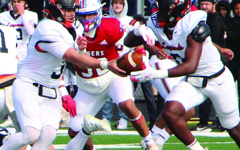 Sentinel Photo/Jessica Shepard Van Vleck quarterback Wade Hutson hands off to  Leopard running back Corey Austin in first quarter action against Tidehaven.