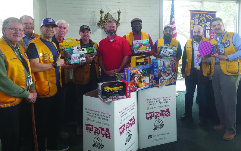 Contributed photo Bay City Lions Club members show off a collection box for the “Toys For Tots” campaign at businesses around the county. Lion's members brought toys to their meeting to donate. The Lions club also donated $500 to the campaign.