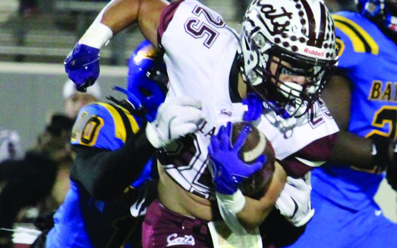Sentinel Photo/Mike Reddell Linebacker Davonte A Harris (10) grabs a hold of a Calallen running back to help stall a Wildcat offensive drive.