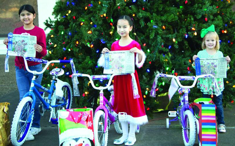 Sentinel photo/MaLinda Reddell This year's Sentinel Christmas Coloring Contest winners are from left, Alexa Rubio, Nadia Flores, and Allie Schneider. Each girl received a bicycle, a blue ribbon for their artistry, and a Christmas bag and stocking full of candy and other treats.