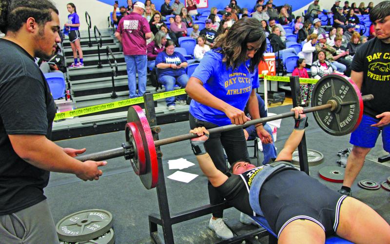 Sentinel Photo/Mike Reddell Bay City’s Camryn Garcia, below, on the bench press, while assistant coach Cierra Bernard spots the lift.