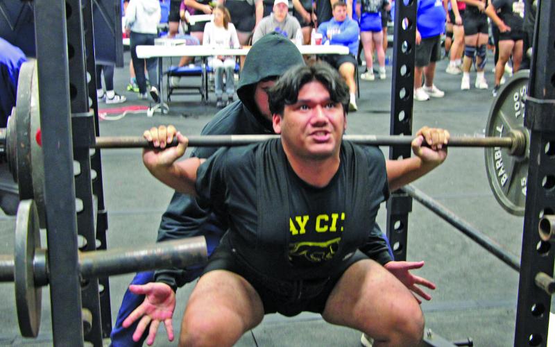 Sentinel Photo/Mike Reddell Blackcat powerlifter Jacob Perez strains in the squat under the watching eye of Coach Ron Arneso at the Tidehaven PL meet.