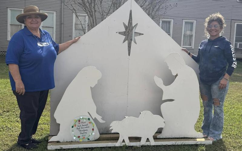 First place winner for "Best Decorated Yard Display" went to the nativity scene by Katie Claxton, not pictured. Shown are Debbie Davant, left, and Darbi Crain.  Not pictured are the second place winner Christmas Hay Bale by Pokie and Mary Pierce and third place winner, the Cactus Cowboy, by Maddie, Elvy, Levi and Trevor Bloom Contributed photos
