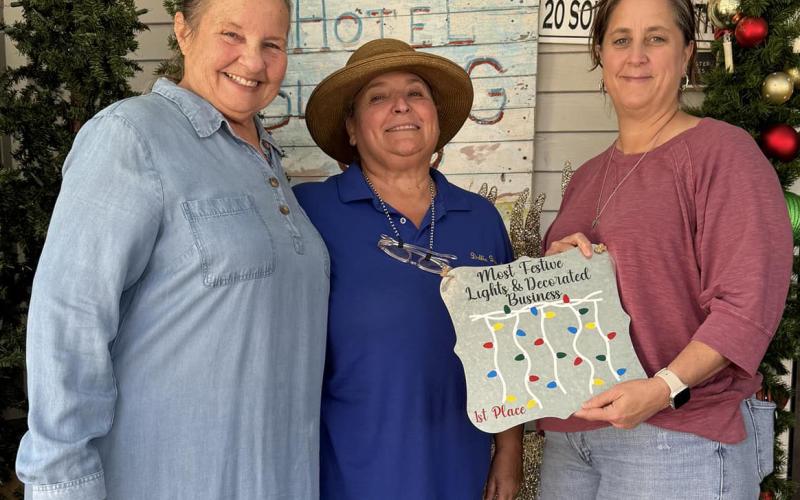First place winner for "Best Decorated Business" was the Hotel Blessing, represented by Mary Pierce, left, Debbie Davant, center, and Jedie Zarate. Not pictured, second place winner First State Bank,  and third place winner Split Ends Contributed photos