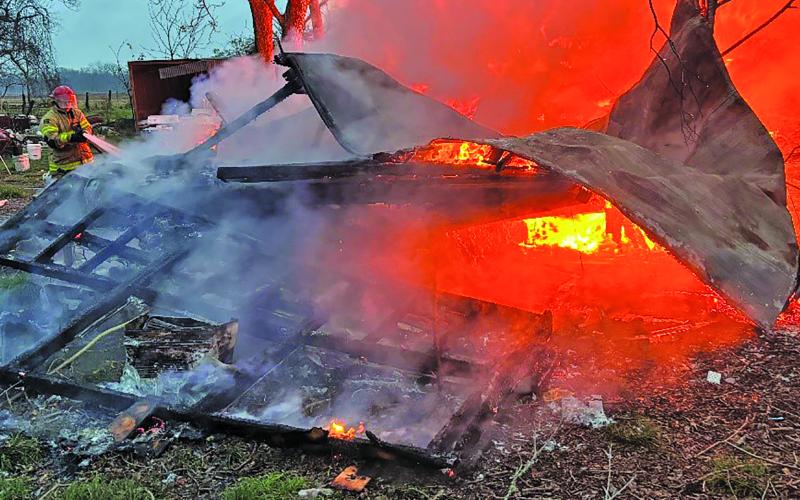 Dan Shook photo A firefighter battles a blaze that destroyed a trailer house in Van Vleck Jan. 15. A faulty space heater was given as the probable cause.