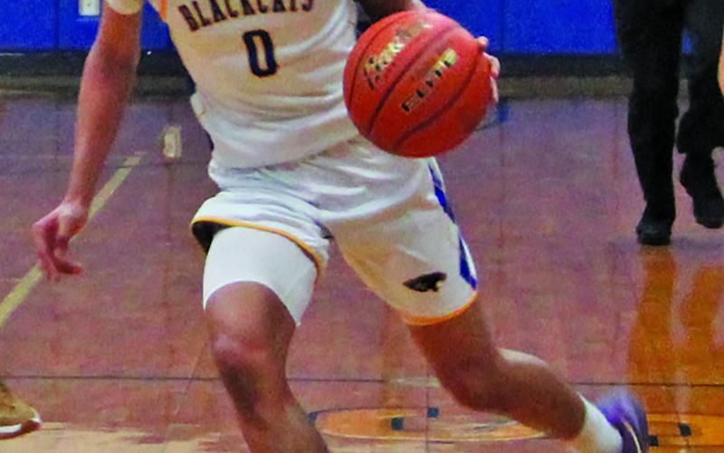 Sentinel Photo/Mike Reddell Bay City Blackcat AJ Molina (0) moves the ball down court against Columbia, Friday, Feb. 7. The Blackcats won 59-44. Bay City, as of last Friday, was 11-10, 6-7, and fourth in district. They played Brazosport Tuesday, Feb. 11.