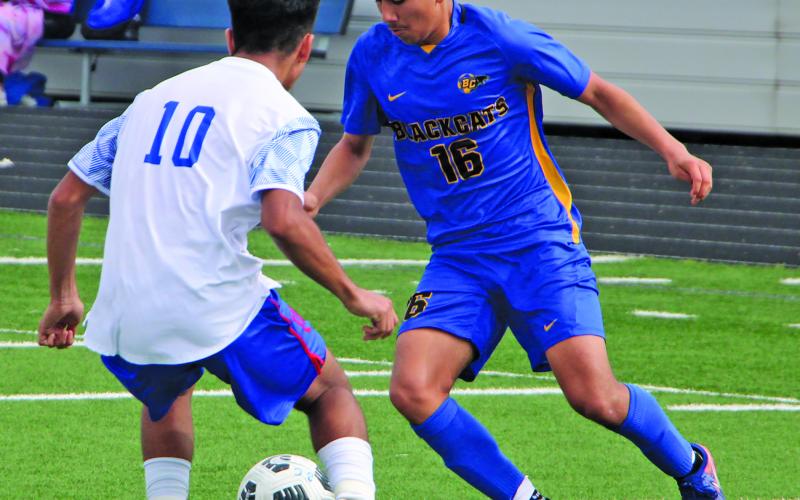 Sentinel Photo/Mike Reddell Blackcat Christopher Martinez (16) works the ball around a Wharton defender in action Saturday at Memorial Stadium.