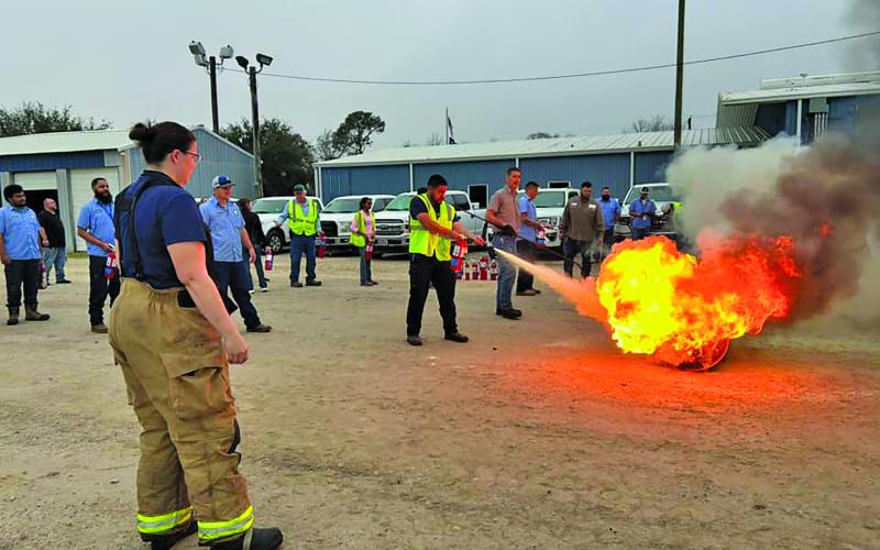 Contributed photo All City Staff got a turn practicing putting out a controlled diesel fire last week.