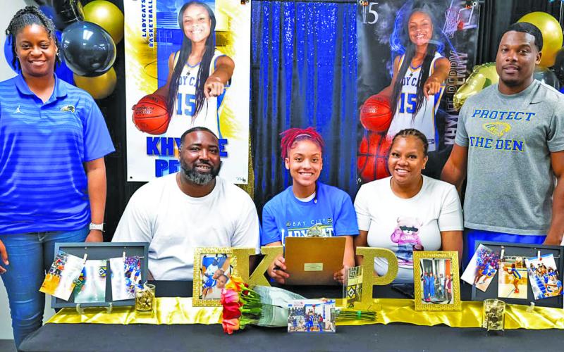 Courtesy photo Bay City Lady Cat guard Khylee Perry signed her letter of intent last week on National Signing Day. Perry will be playing for Hill College.