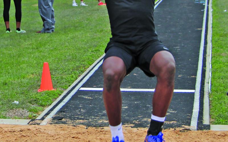 Sentinel Photo/Mike Reddell Blackcat Keimarion Wiggins makes his leap in the broad jumping event at the Relays.